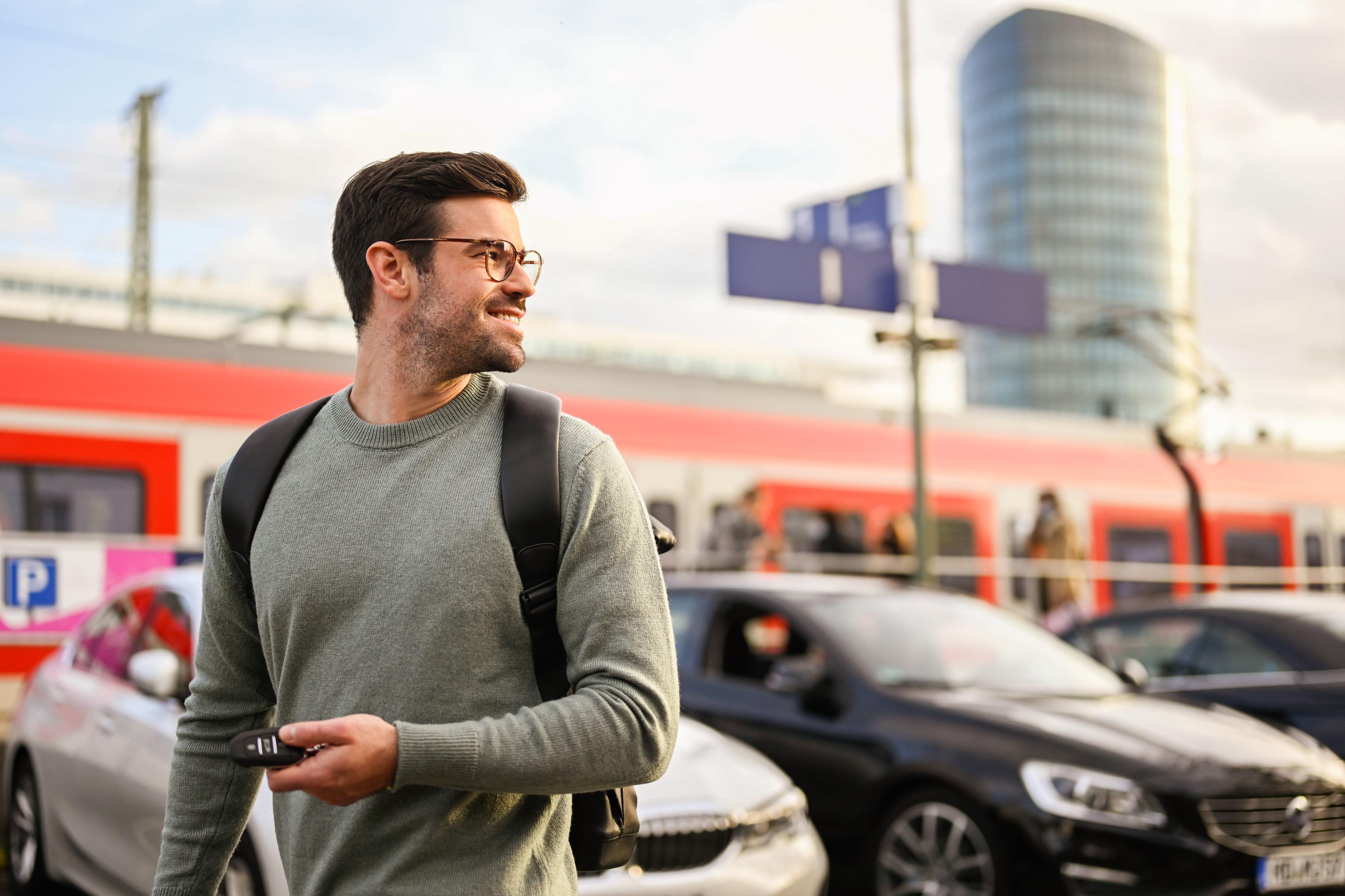 A traveler parks his car in a parking space at the train station.